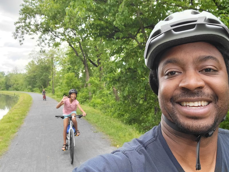 Jaquan — Thandi's Dad — selfie on the Delaware-Raritan Canal Tow Path with daughter riding behind